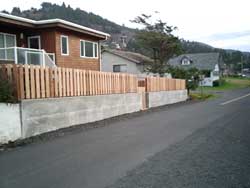 cedar fencing with concrete retaining wall